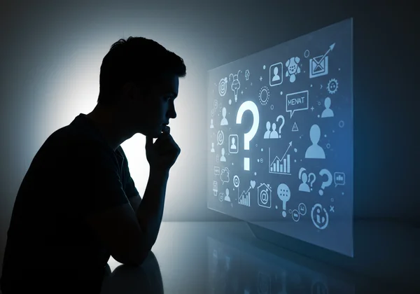 A person pondering their traits, seeing a question mark reflection