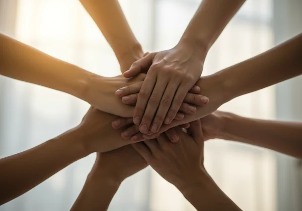 Multiple hands interlocking, symbolizing a strong support system.